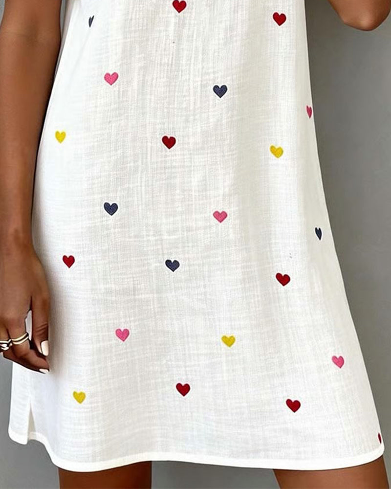 Feminine women's mini dress with charming heart print, puff sleeves & V-neck. Ideal relaxed fit for casual summer.