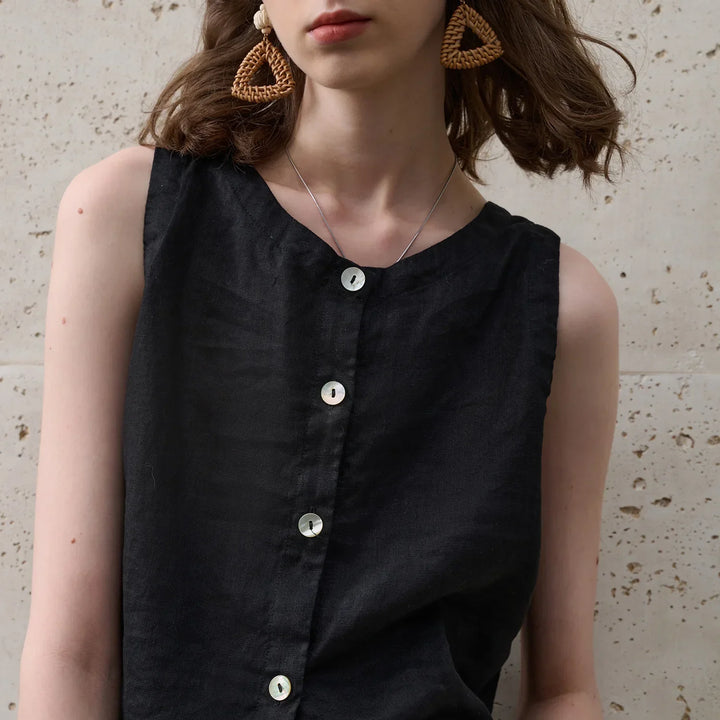 Modern women's asymmetric crop top, featuring a sleeveless design and crew neck. Great for versatile fashion.