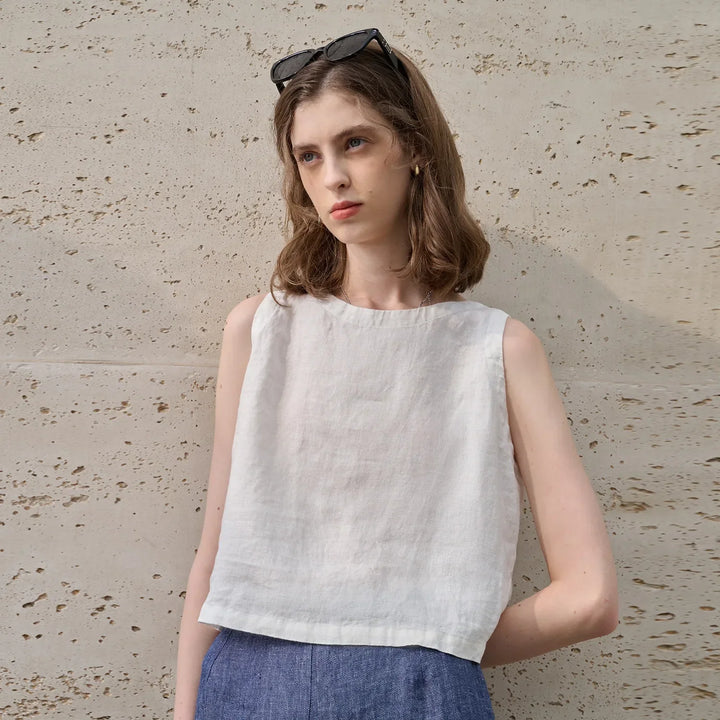 Women's stylish sleeveless asymmetric crew neck crop top. A comfortable and trendy choice for summer outfits.