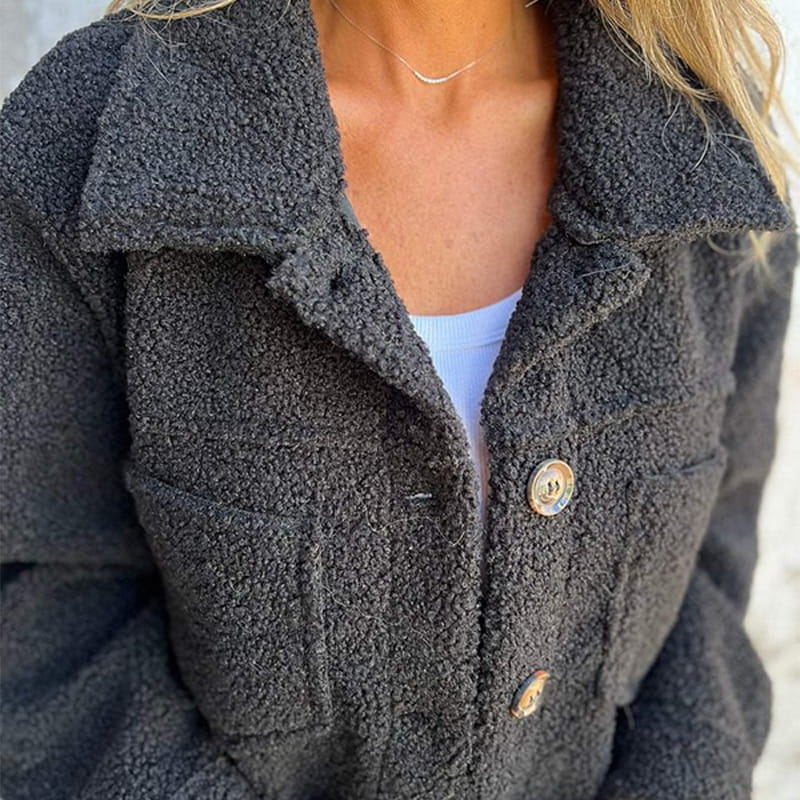 Women's chic button-up autumn coat with a stylish notch collar. Perfect elegant outerwear for fall.