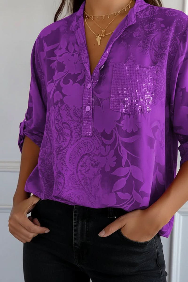 Woman modeling a chic printed long-sleeve blouse with a front pocket, ideal for workwear or casual style.