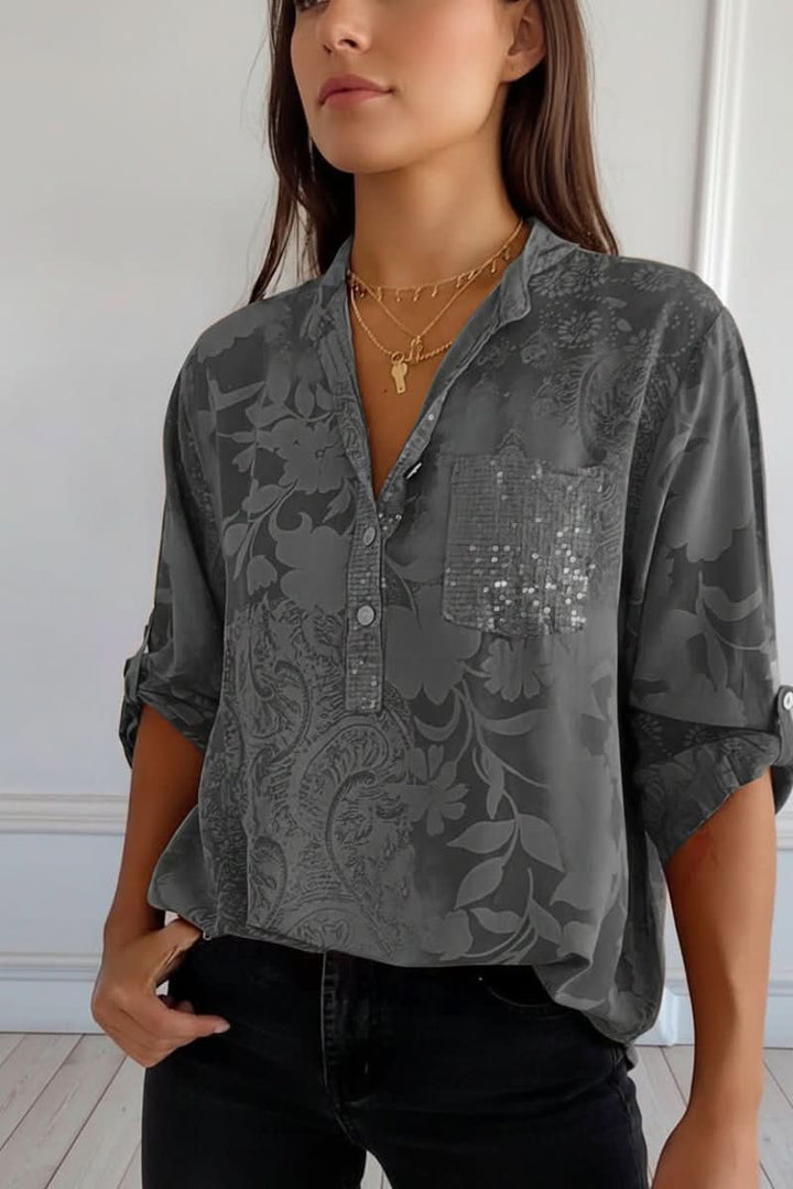 Women's elegant printed long-sleeve blouse featuring a practical front pocket. Chic & versatile summer top.