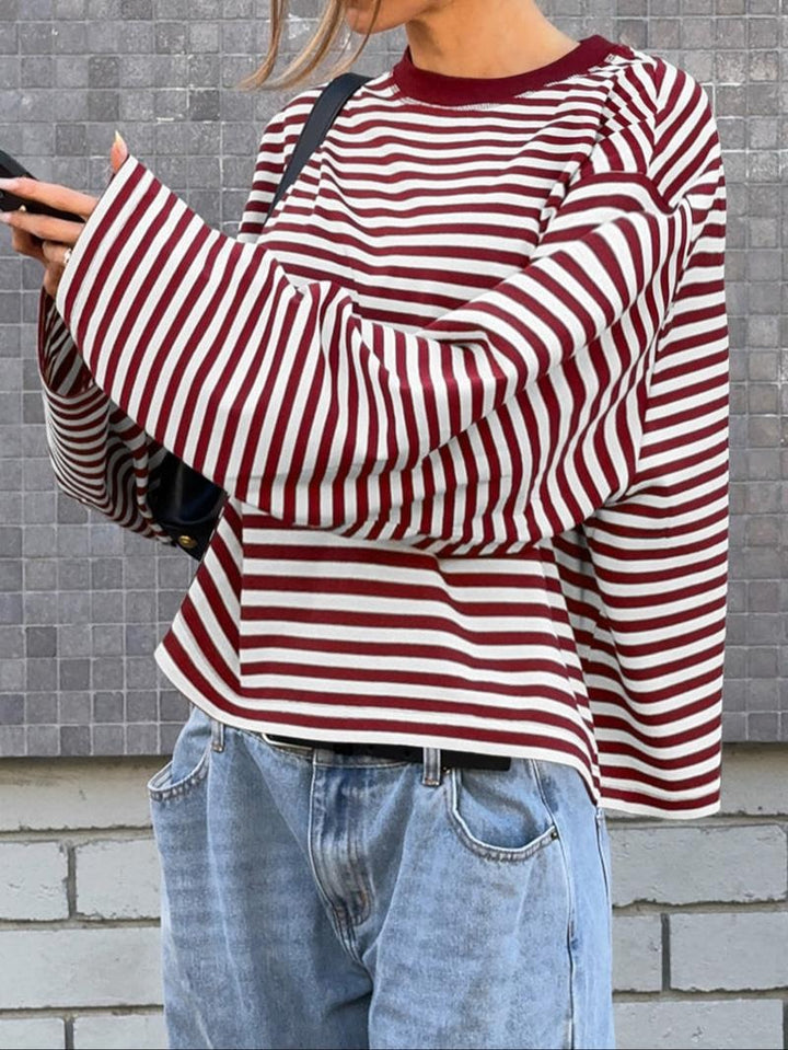 Elegant women's striped bell sleeve top. Chic long sleeve pullover sweater, a stylish statement piece for women.