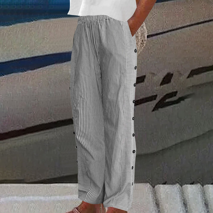 Relaxed fit women's striped pants with decorative side buttons, trendy and comfortable for casual wear.