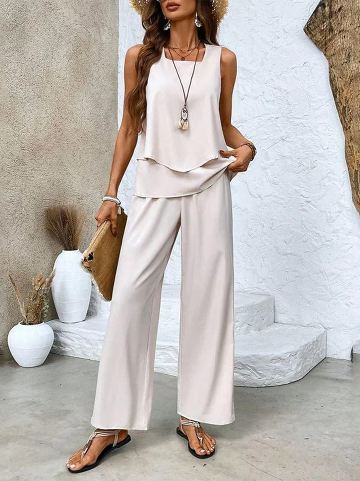 Fashionable women's two-piece summer outfit with a flowy top & wide-leg pants. Elegant and casual chic.