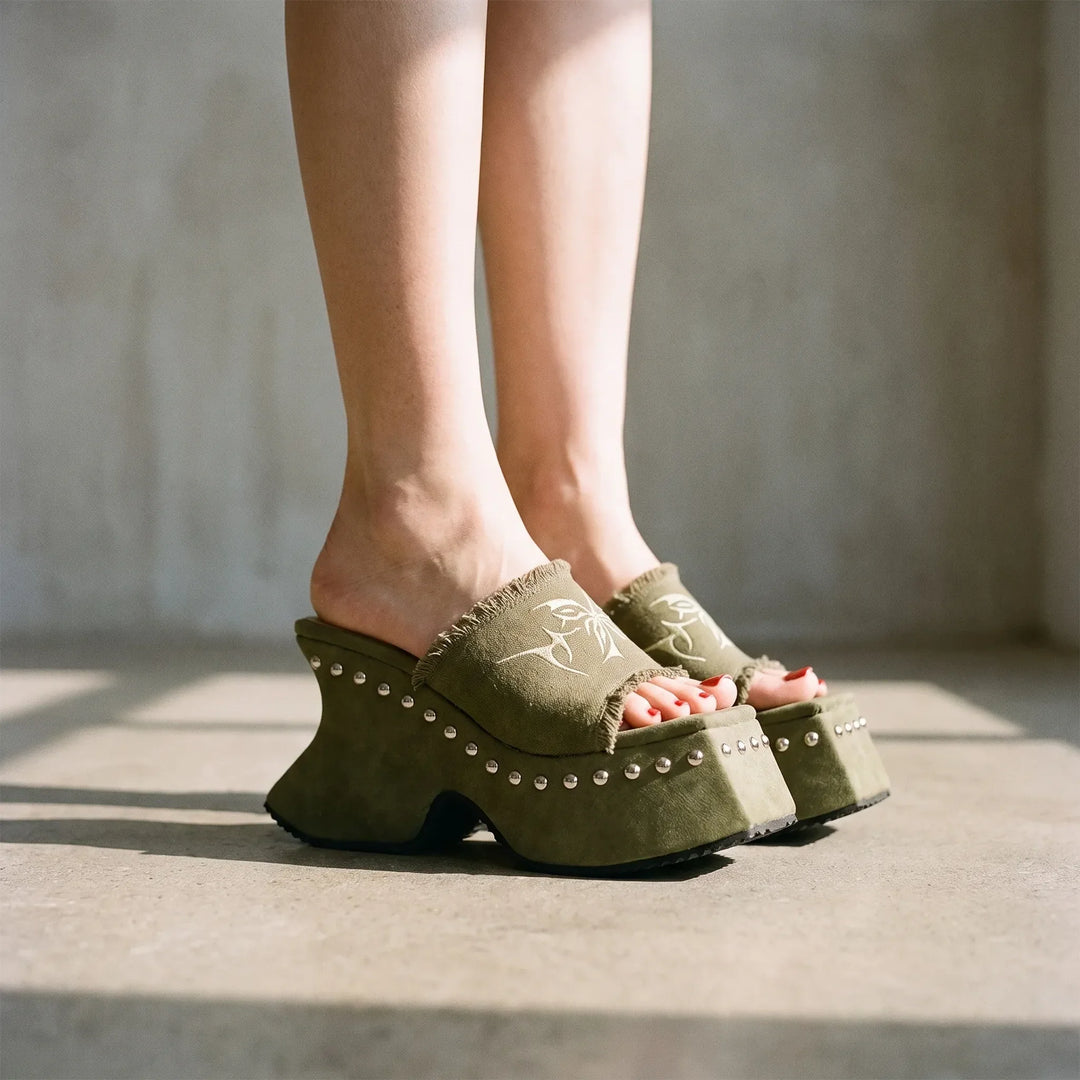 Women's chunky platform slip-on sandals featuring a retro block heel. Perfect for stylish summer casual outfits.