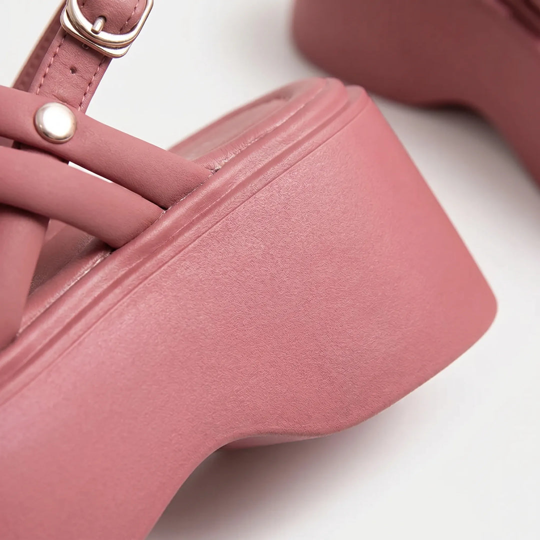 Fashionable women's wedge sandals with criss-cross straps, chunky platform, and secure adjustable ankle closure.