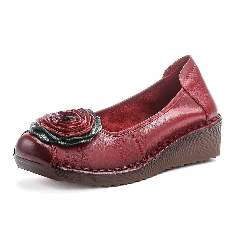 Side view of women's casual slip-on loafers, showcasing the comfortable design and floral appliqué detail.