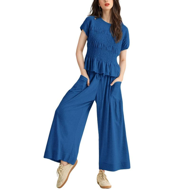 Fashionable women's smocked top, part of a casual wide-leg pant two-piece cotton blend set.