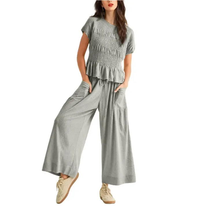 Elegant women's two-piece set: smocked top and wide-leg pants. Versatile for casual outings or loungewear.