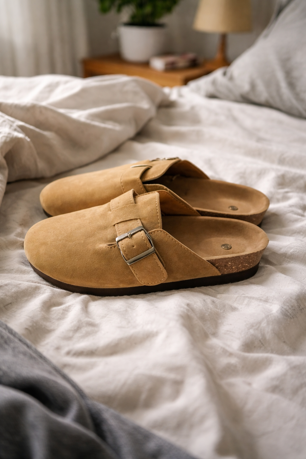 Women's comfortable slip-on clogs with adjustable buckle strap, perfect for casual everyday wear.