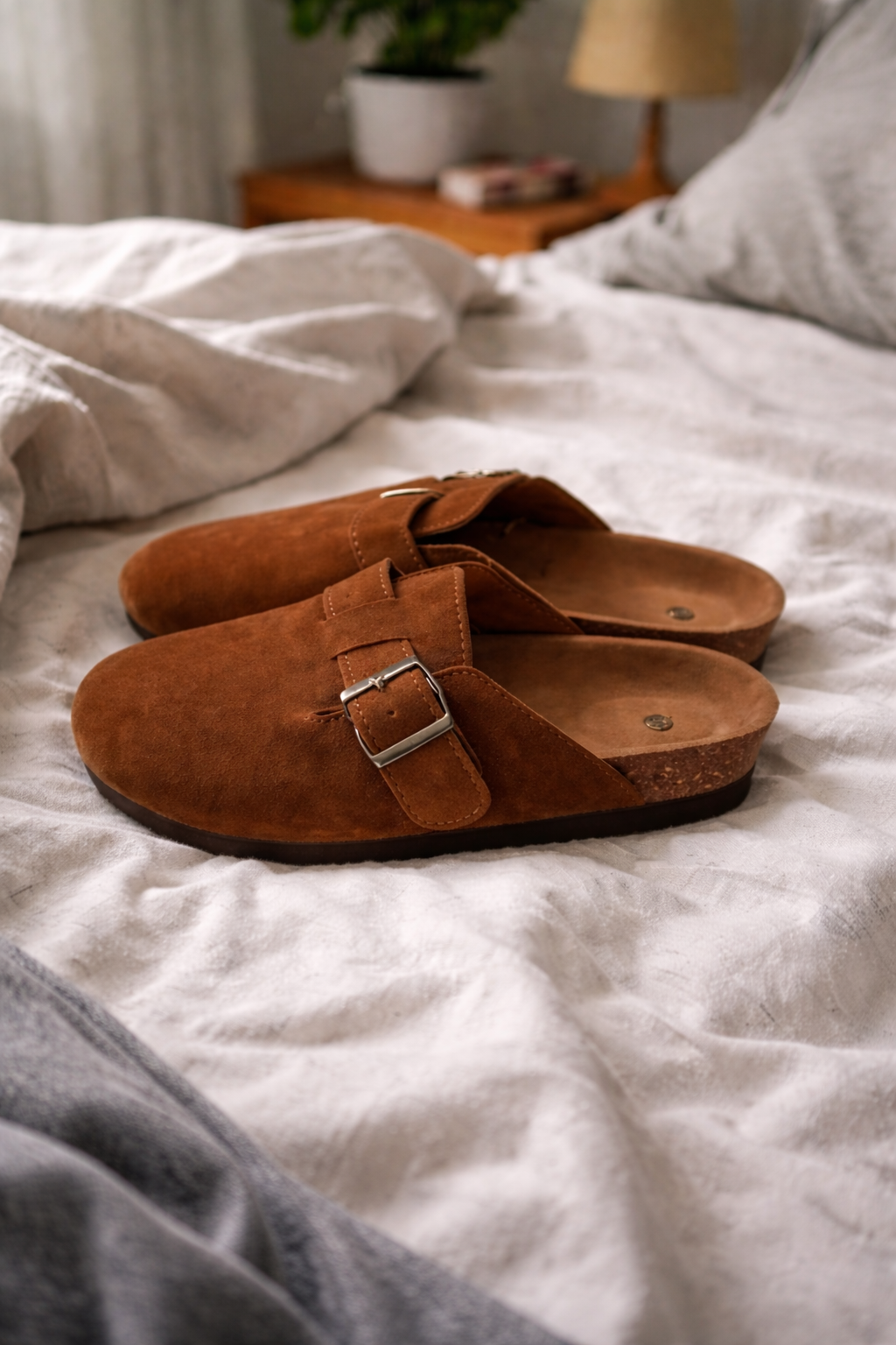 Stylish women's clogs featuring a comfortable design and decorative buckle strap, ideal casual footwear.
