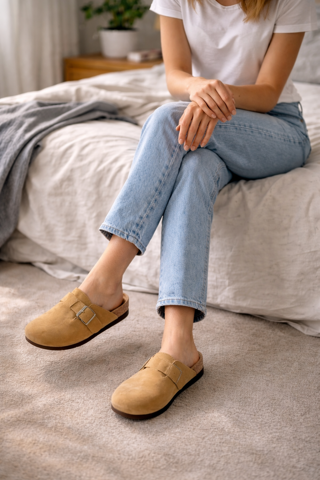 Everyday women's footwear: comfortable clogs with a secure buckle strap and open heel for easy wear.