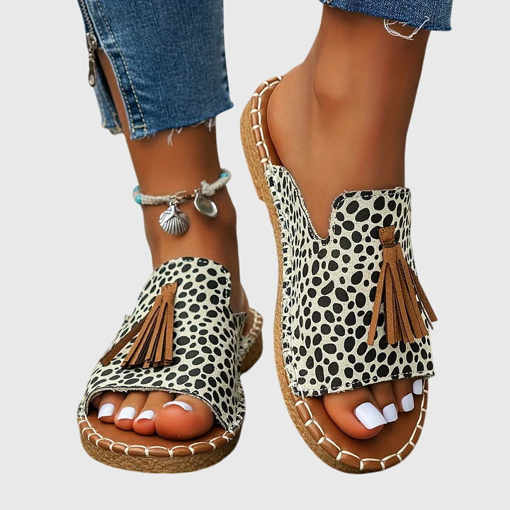 Fashionable women's casual sandals with chic tassel straps, perfect slip-on summer footwear.