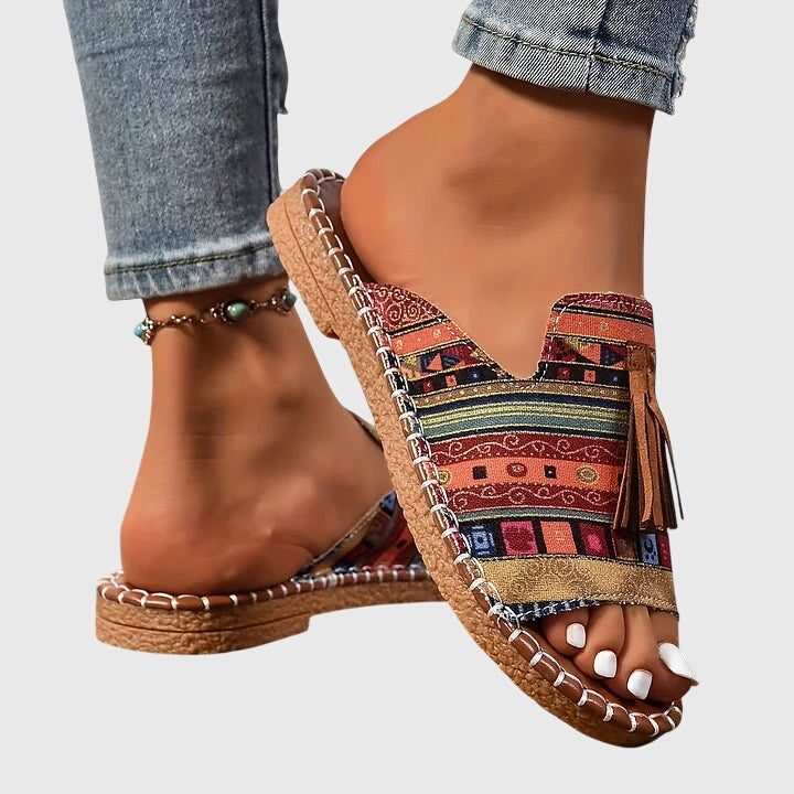 Flat sole women's slip-on sandals for ultimate comfort, with stylish tassel accents & open toe.