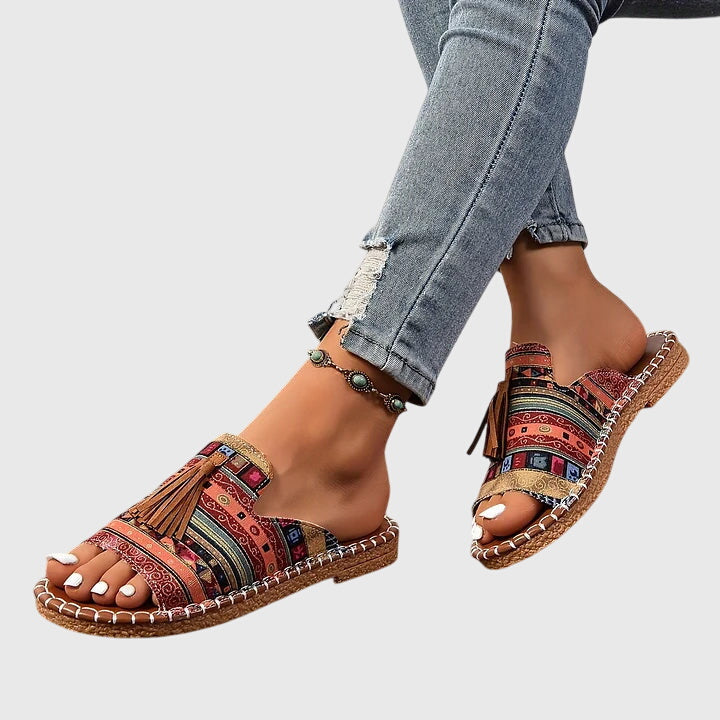 Easy-wear women's casual sandals, slip-on style with playful tassels, great for summer fashion.