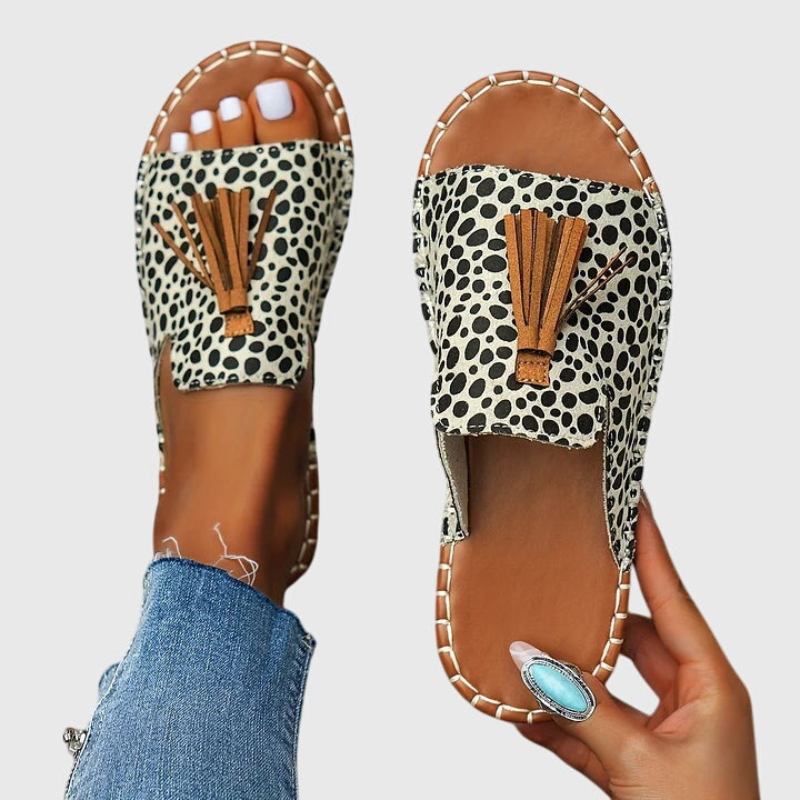 Women's comfortable slip-on tassel sandals; flat sole, open toe, ideal for casual summer style.