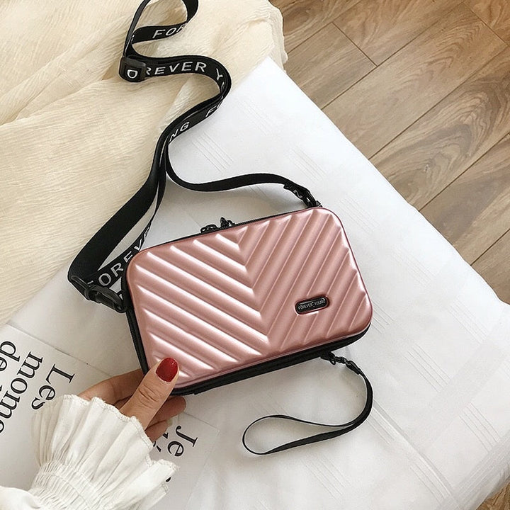 Compact mini hard shell travel crossbody bag for women. Lightweight & portable handbag for essentials.