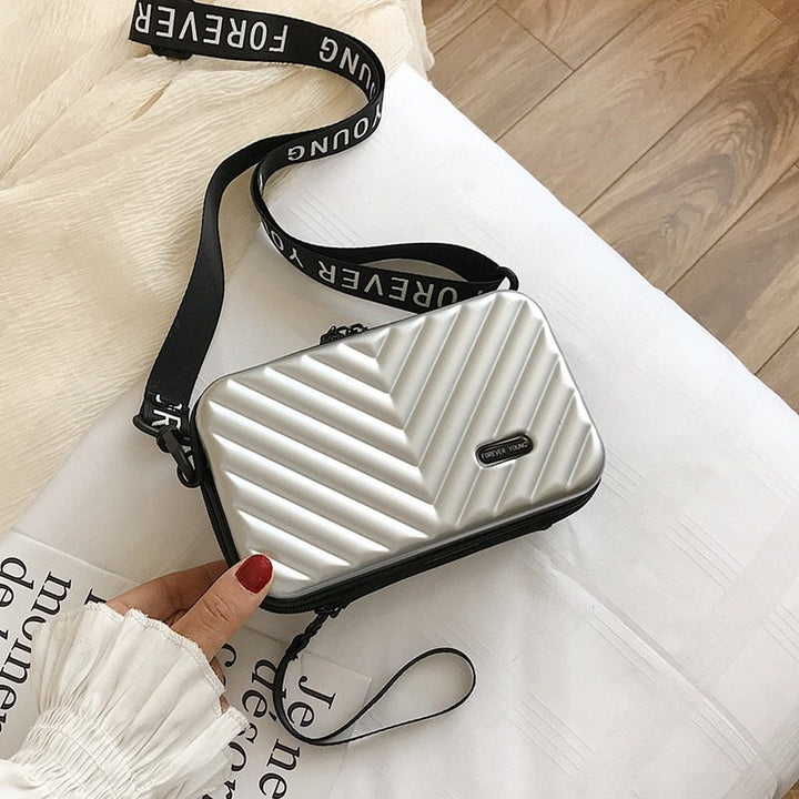 Women's essential hard shell travel crossbody bag. Secure & compact handbag for vacations & adventures.