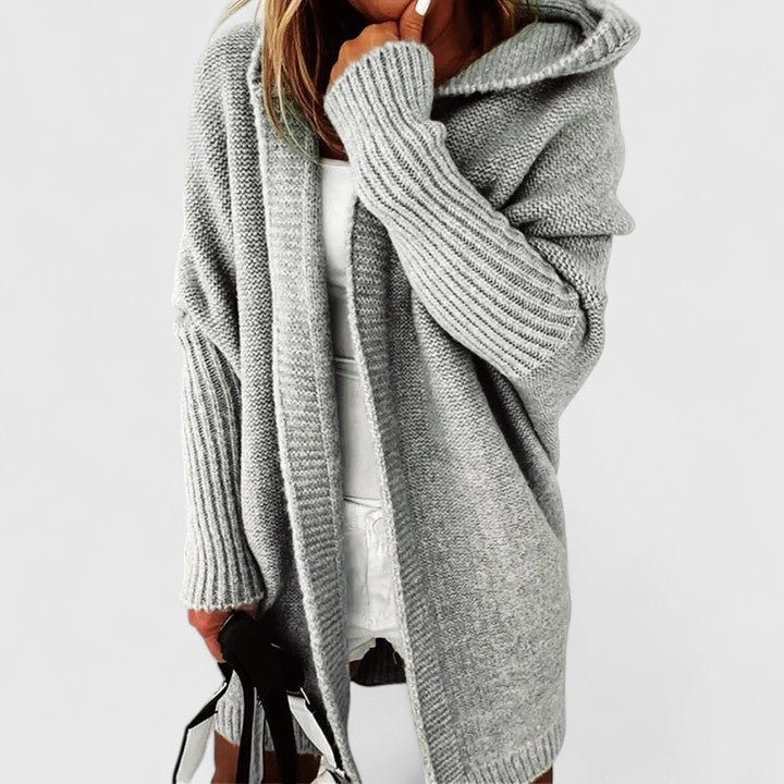 Women's oversized knee-length hooded open-front cardigan, a comfortable and versatile piece for layering.
