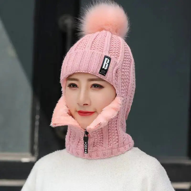 Stretch-fit women's knitted balaclava with pompom, designed for outdoor gear and cozy winter warmth.
