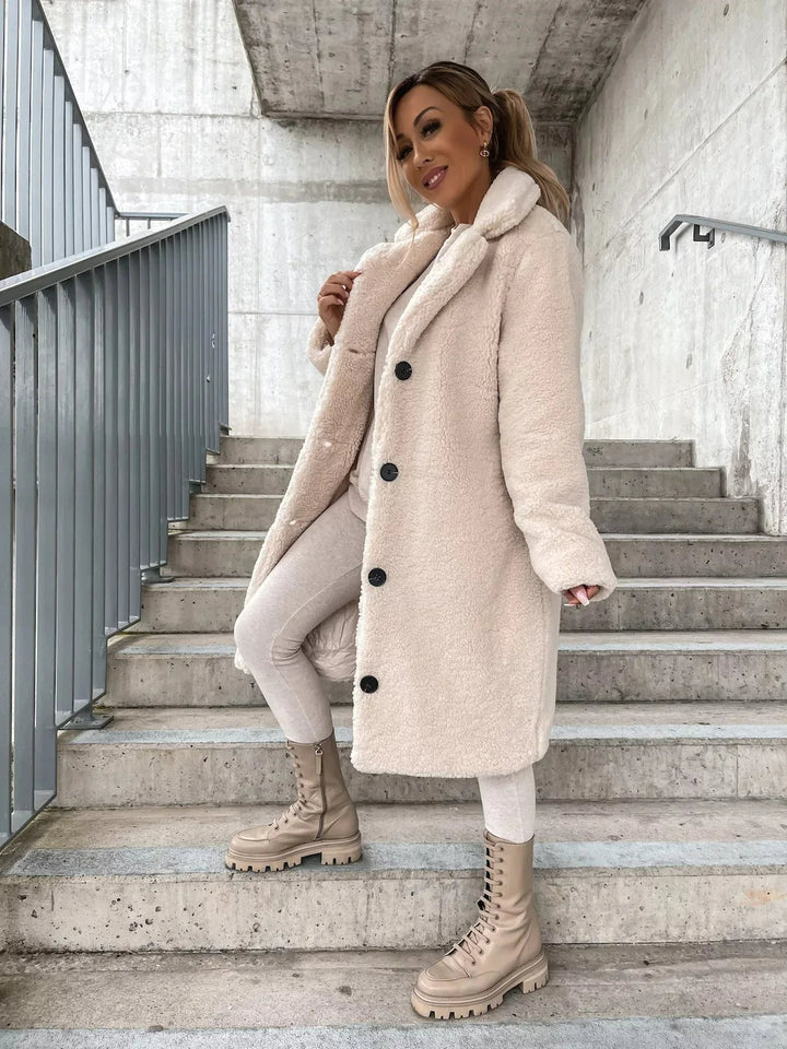 Versatile women's longline plush teddy coat, a cozy fashion staple for elegant autumn and winter.