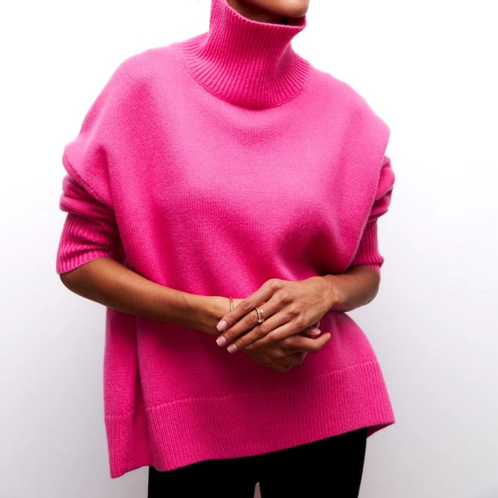 Close-up of soft knit fabric on a women's cozy oversized turtleneck pullover, ideal for loungewear.