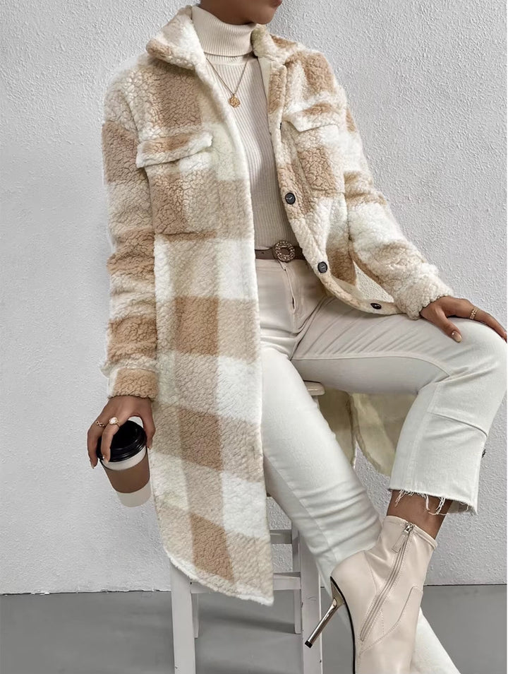 Fashionable women's long plaid winter jacket. Cozy, warm outerwear with a stylish button-up front.