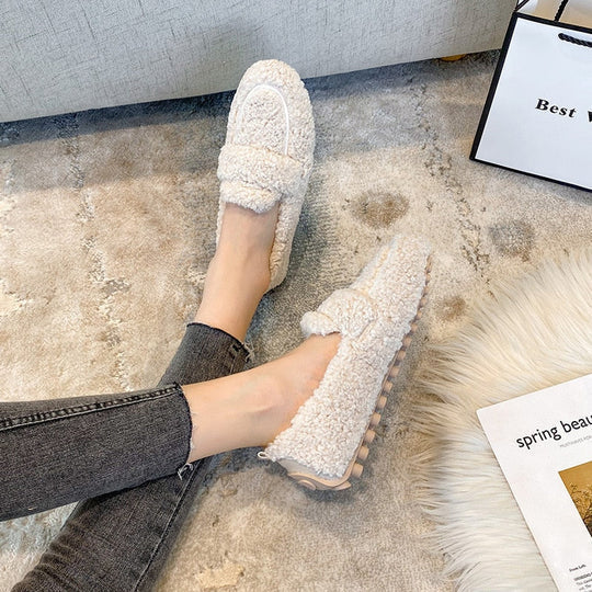 Luxurious plush women's loafer slippers, cozy style offering warmth and relaxation as indoor footwear.