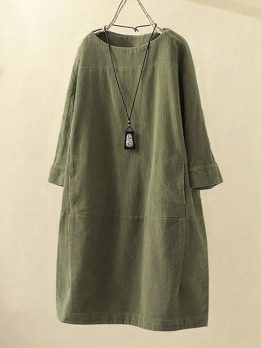 Women's cozy textured midi dress with long sleeves and practical pockets, perfect for fall and winter comfort.
