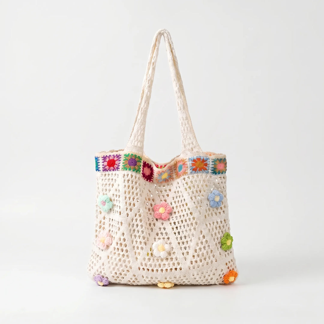 Hand-crocheted women's tote with colorful floral design, ideal shoulder bag for casual summer outings.
