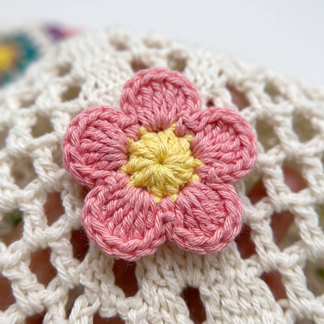 Relaxed bohemian style women's flower crochet tote, a versatile shoulder bag for travel or everyday use.