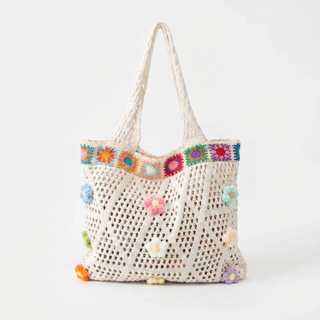 Summer beach bag: open top women's crochet tote with vibrant flower details for a chic, relaxed look.