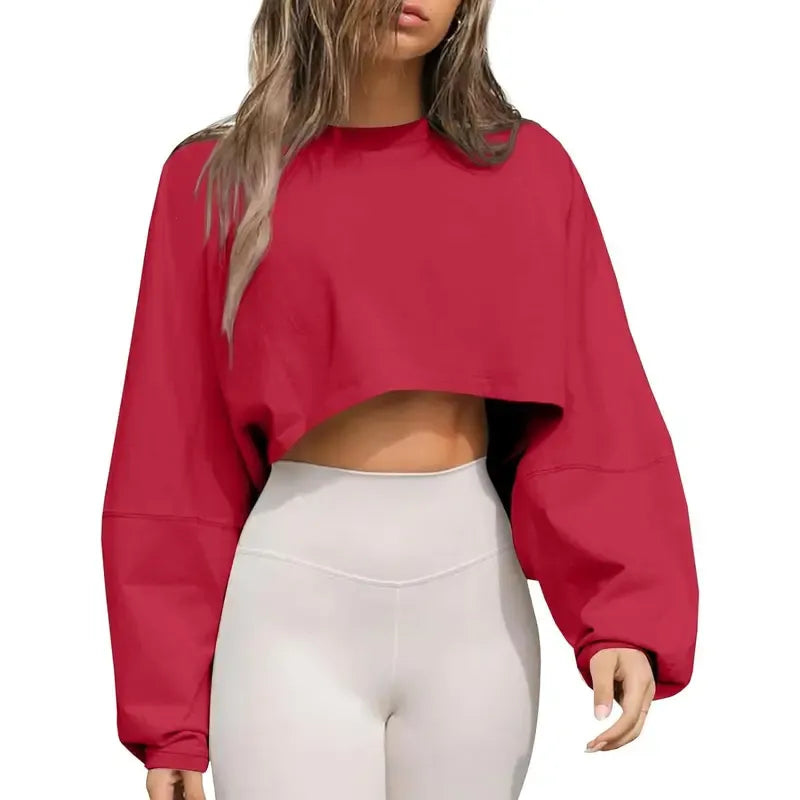 Stylish women's cropped oversized sweatshirt, a versatile crewneck ideal for casual modern outfits.