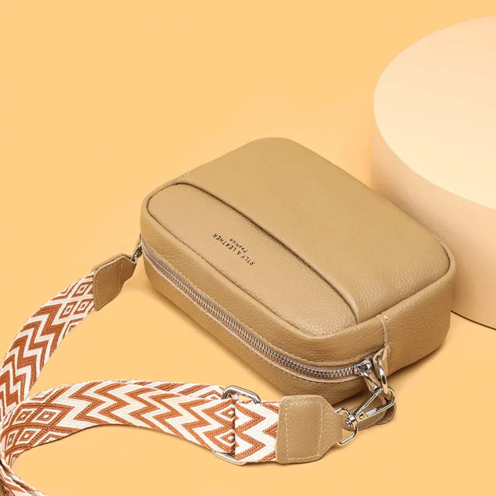 Elegant women's crossbody bag with a standout geometric patterned strap. A chic accessory for any occasion.