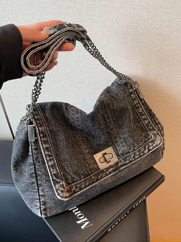 Women's denim shoulder bag with chic chain strap, perfect for casual everyday style and fashion accessory.