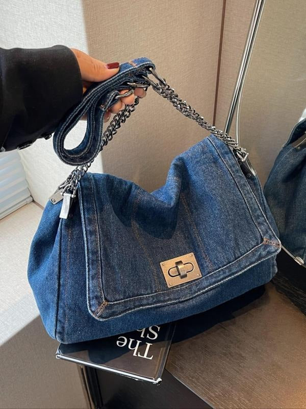 Structured women's denim bag featuring a stylish chain shoulder strap, ideal for a casual chic handbag.