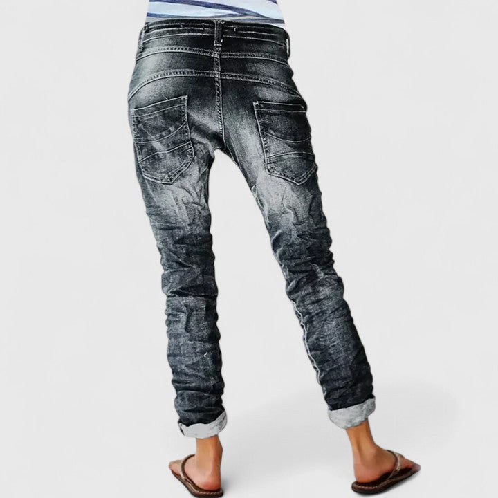 Women's distressed wide-leg jeans, mid-rise, relaxed fit denim, perfect for casual everyday style.