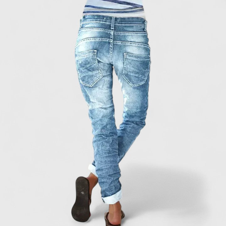Trendy women's wide-leg distressed denim jeans with a relaxed fit and vintage style.
