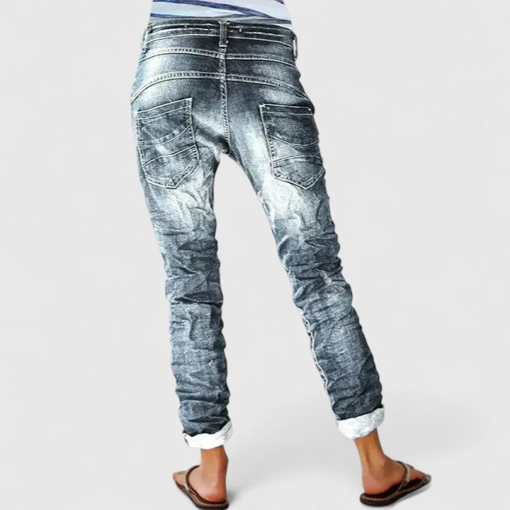Casual women's mid-rise wide-leg jeans, distressed light wash, cuffed hem for effortless fashion.