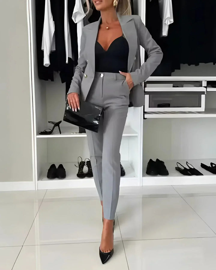 Sophisticated women's tailored double-breasted suit. Professional blazer & trousers set for business attire.