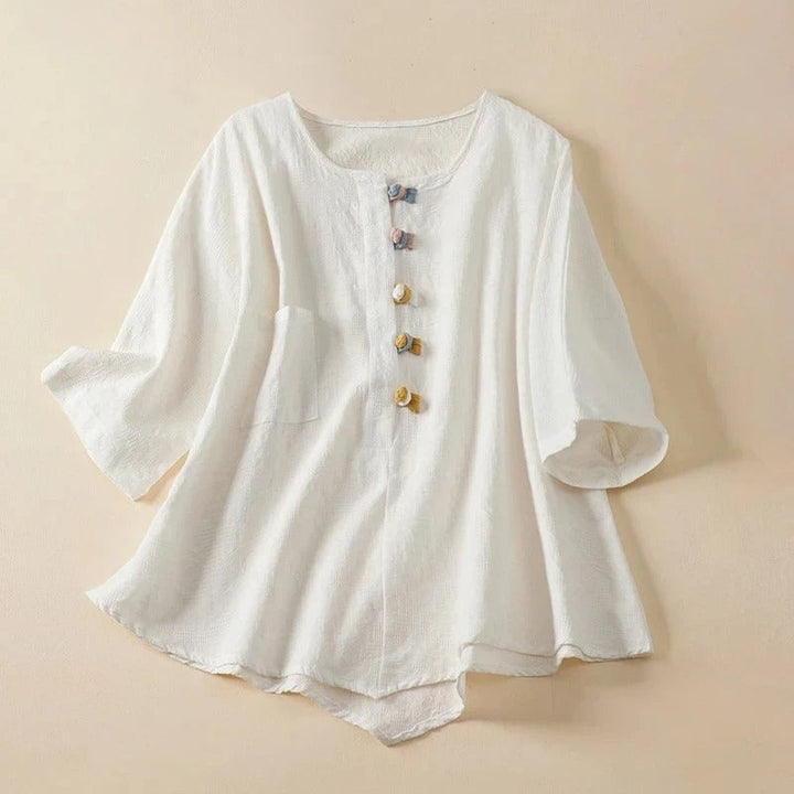 Elegant women's Eden Blouse. Long sleeve button-up shirt with draped fit & unique knotted buttons for spring/summer.