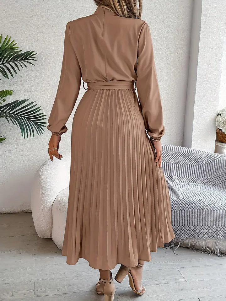 Flattering women's long-sleeve midi dress, elegantly belted with a beautifully pleated skirt.