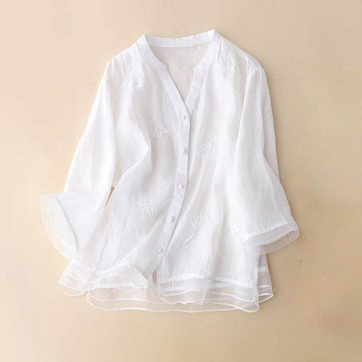 Chic women's V-neck blouse with intricate embroidery, ideal for spring casual or office wear. Breathable.