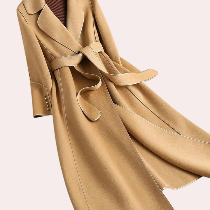 Classic women's long coat, featuring a double-button front and flattering belted waist. Elegant winter outerwear.