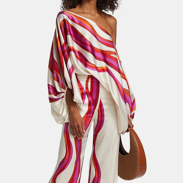Women's elegant one-shoulder printed two-piece pants set with abstract design, ideal for chic resort wear.