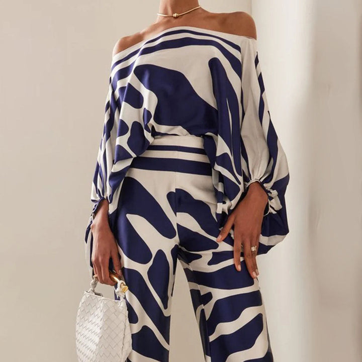 Artistic abstract print two-piece set for women, featuring a stylish one-shoulder top & elegant wide-leg pants.