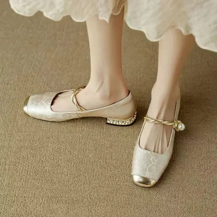 Low-heel women's dress flats featuring elegant pearls, a metallic toe, and ultimate cushioned comfort.