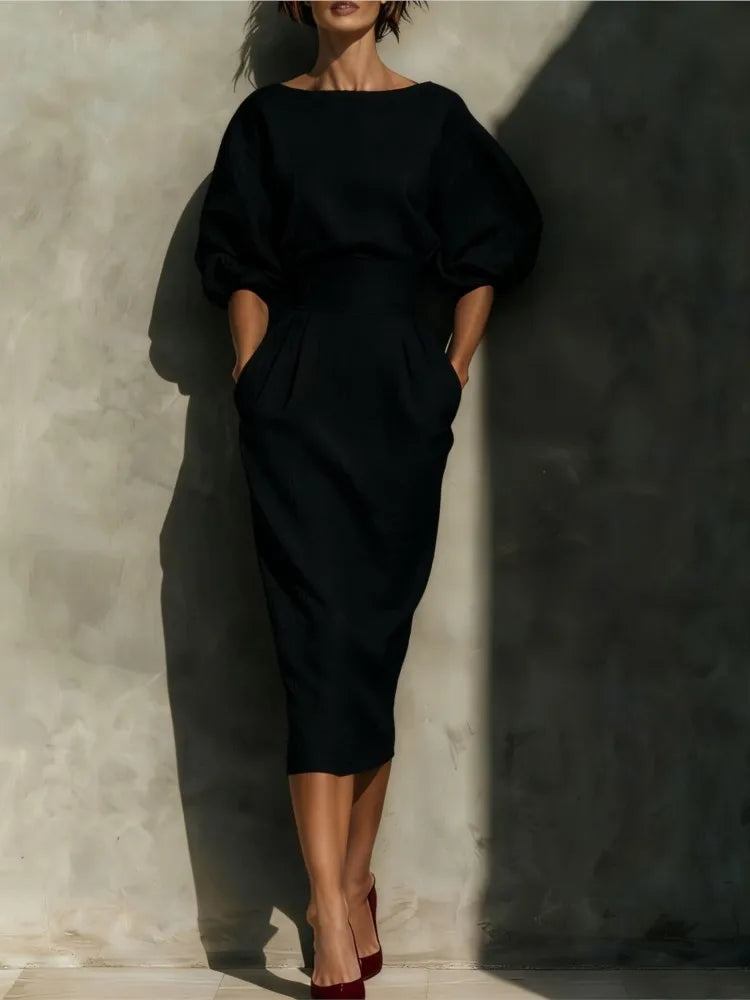 Fashionable women's puff sleeve midi dress with pockets, offering a chic and versatile look for any season.