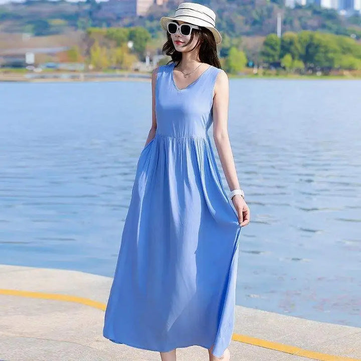 Women's V-neck maxi dress, featuring an adjustable tie waist, sleeveless top & discreet pockets.